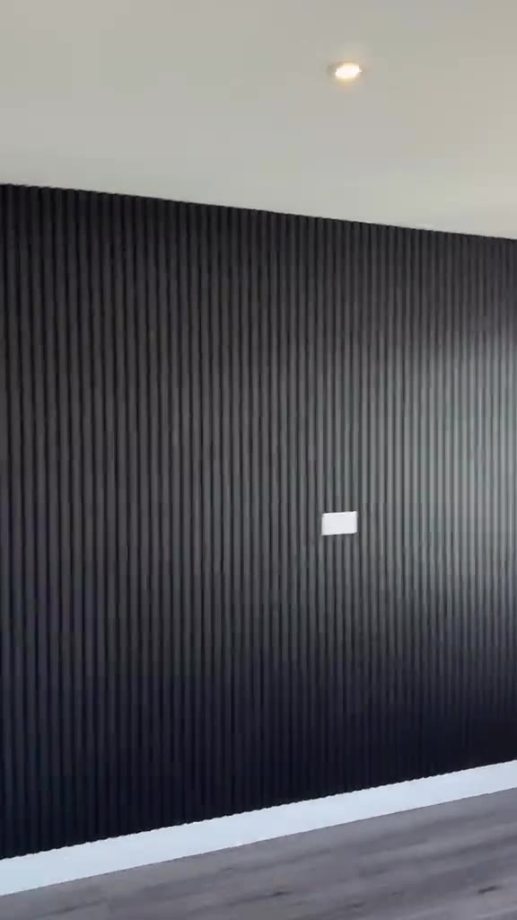 Finished room with a black slatted feature wall