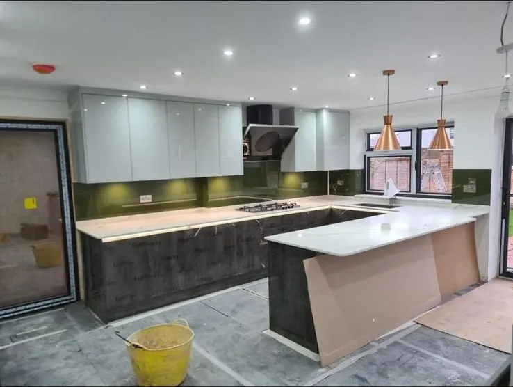 New open-plan kitchen with island, quartz worktops and copper pendant lights